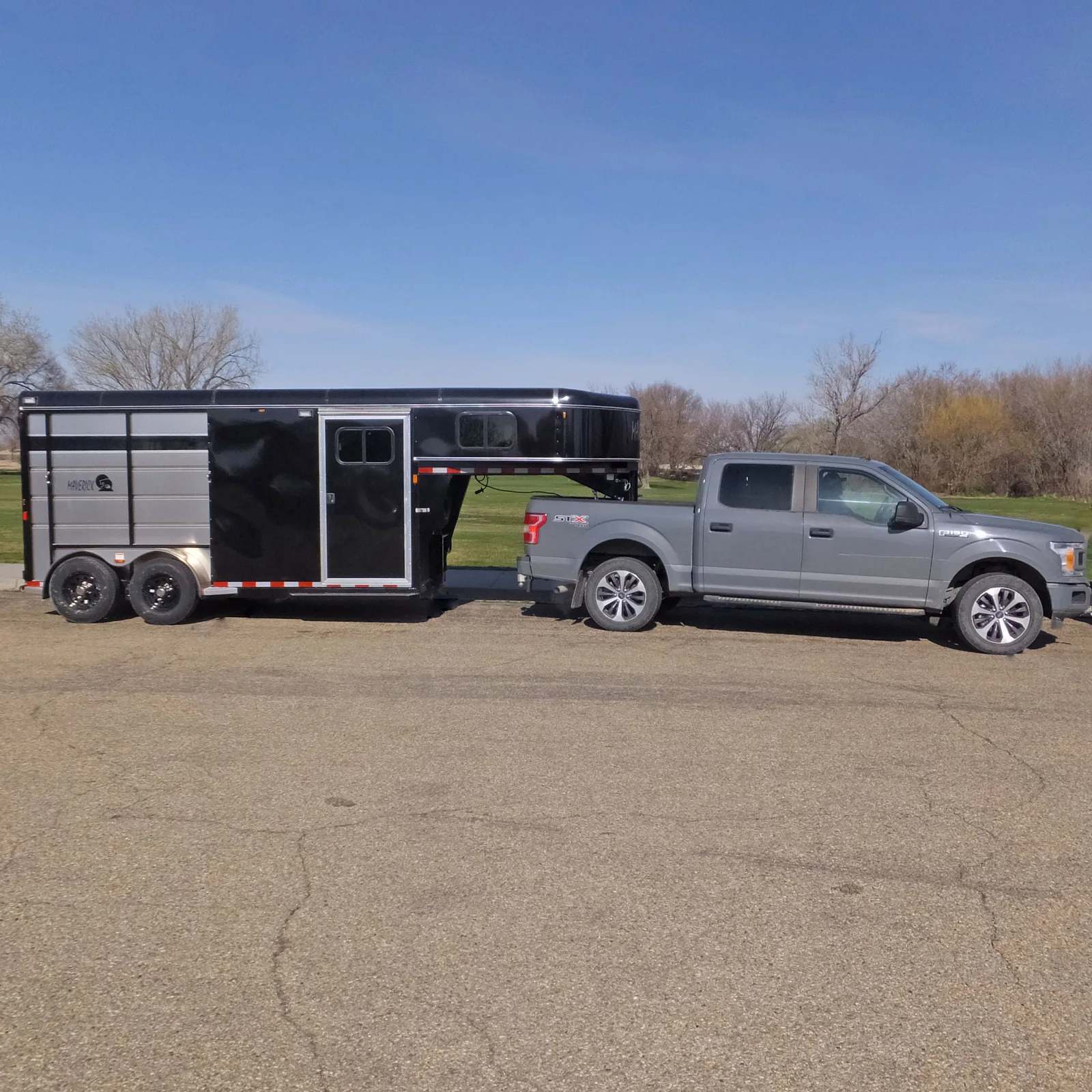 Maverick 2 horse gooseneck in black being towed with f150.